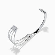 The 14K White Gold Pave Diamond Crisscross Bangle features an open, wavy design adorned with sparkling diamonds along the curves for an elegant, delicate look.