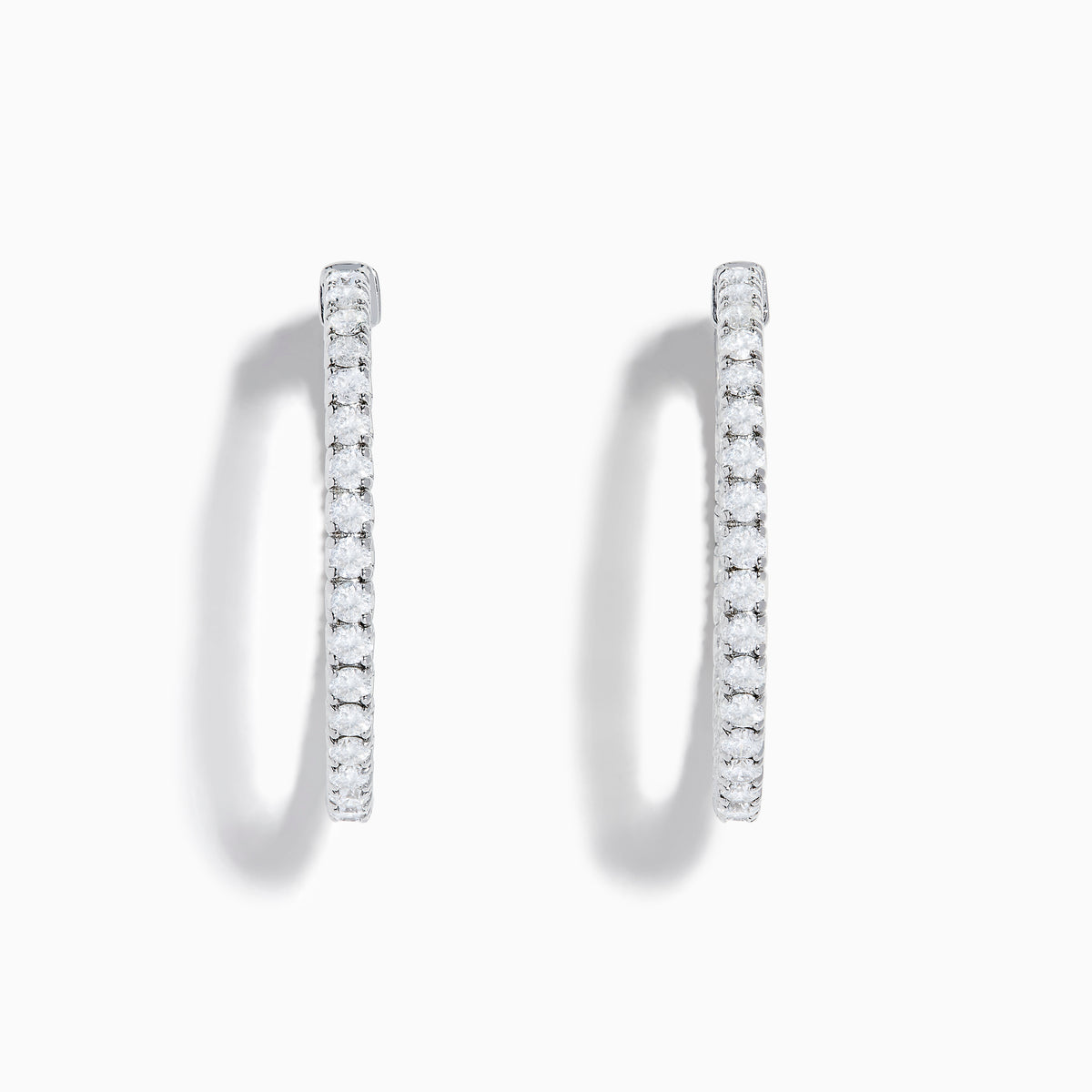 The 14K White Gold Inside Out Diamond Hoop Earrings (2.00 TCW) are shown vertically on a plain white background, with their shadows cast to the side.