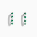A pair of 14K white gold emerald & diamond hoop earrings, 1.10 TCW, featuring alternating green and clear gemstones set in a silver band, displayed on a white background with soft shadows.