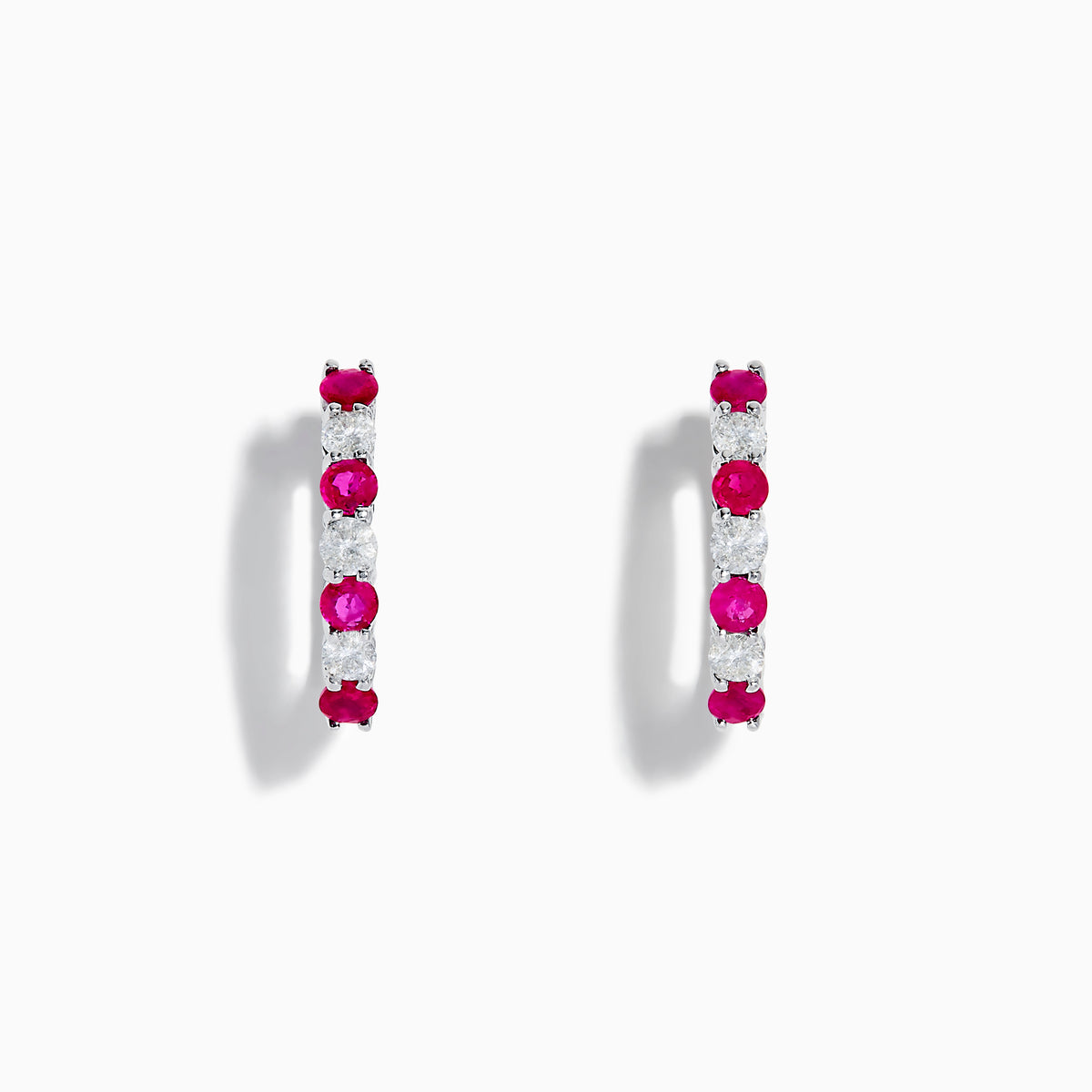 A pair of 14K White Gold Ruby & Diamond Hoop Earrings, 1.10 TCW, featuring alternating round red rubies and clear diamonds, displayed on a white background with each earring casting a soft shadow.