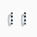 The 14K White Gold Blue Sapphire & Diamond Hoop Earrings, 1.10 TCW, are shown on a plain white background with soft left-side shadows, highlighting alternating sapphire and diamond stones.