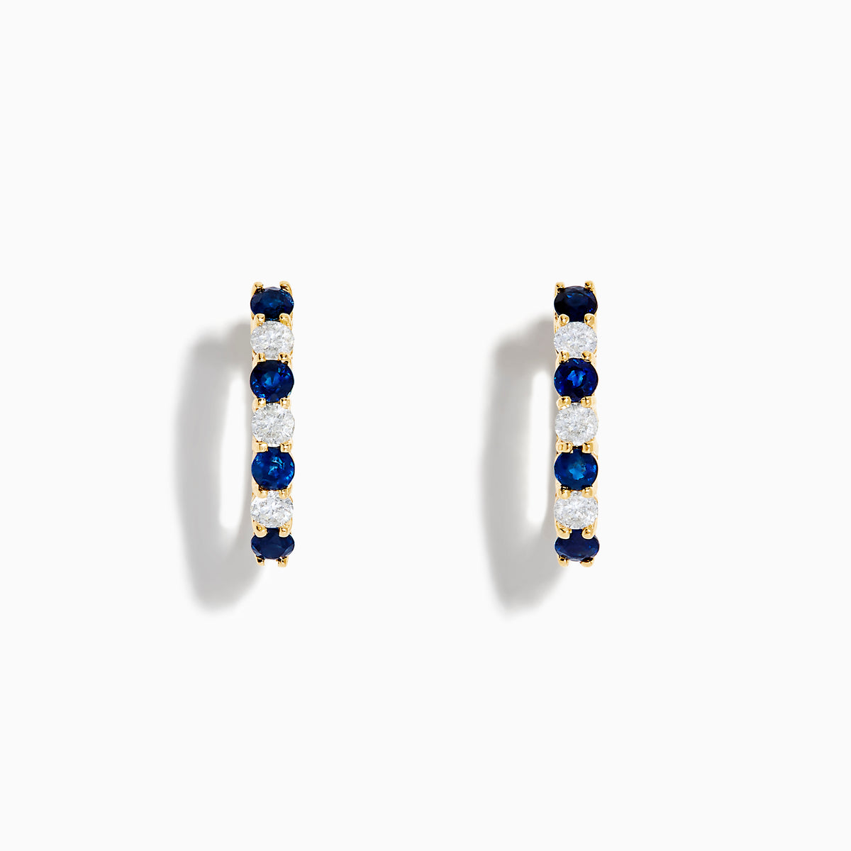 The 14K Yellow Gold Blue Sapphire & Diamond Hoop Earrings, 1.10 TCW, feature alternating sapphires and diamonds in a classic hoop design, shown on a plain white background with visible shadows.