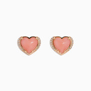 The 14K Rose Gold Pink Opal and Diamond Heart Stud Earrings feature pink heart-shaped centers accented with sparkling diamonds, shown on a white background.
