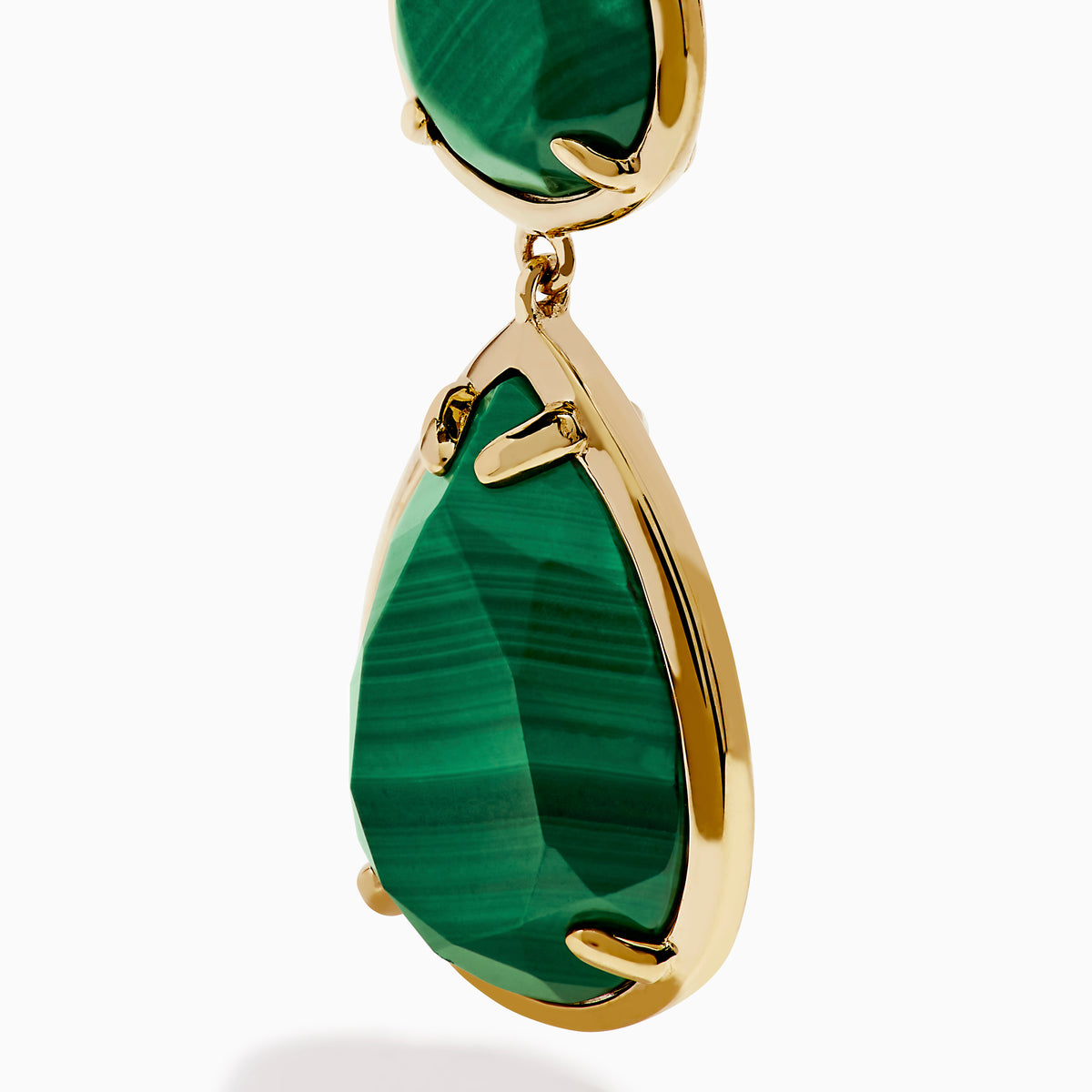 The 14K Yellow Gold Malachite and Diamond Linear Drop Pear Earring features three vertically arranged, teardrop-shaped green malachite stones in gold bezels, accented with diamonds and displayed on a white background.