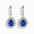 The Effy Hematian 18K White Gold Tanzanite and Diamond Halo Drop Earrings feature large teardrop-shaped blue tanzanites encircled by two rows of sparkling diamonds set in white gold.