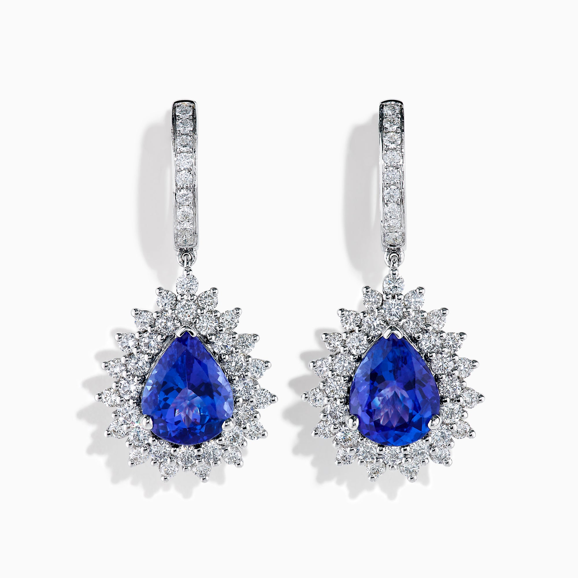 The Effy Hematian 18K White Gold Tanzanite and Diamond Halo Drop Earrings feature large teardrop-shaped blue tanzanites encircled by two rows of sparkling diamonds set in white gold.