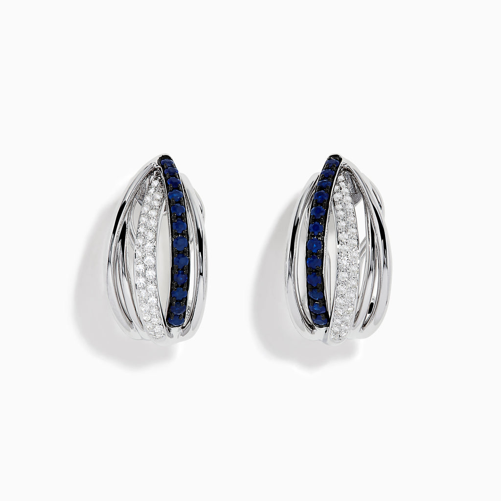 The Royale Bleu 14K White Gold Blue Sapphire & Diamond Earrings (0.62 TCW) feature intersecting bands—one adorned with white diamonds, the other with blue sapphires—shown on a white background.