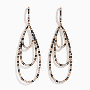 The 14K Rose Gold Espresso, Black, and White Diamond Cascading Teardrop Statement Earrings feature layered loops with alternating diamonds, recalling diamond teardrop elegance on a white background.