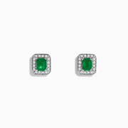 The 14K White Gold Emerald and Diamond Stud Earrings, 1.11 TCW, feature rectangular emeralds bordered by sparkling round diamonds, all set in white gold and shown on a plain white background.