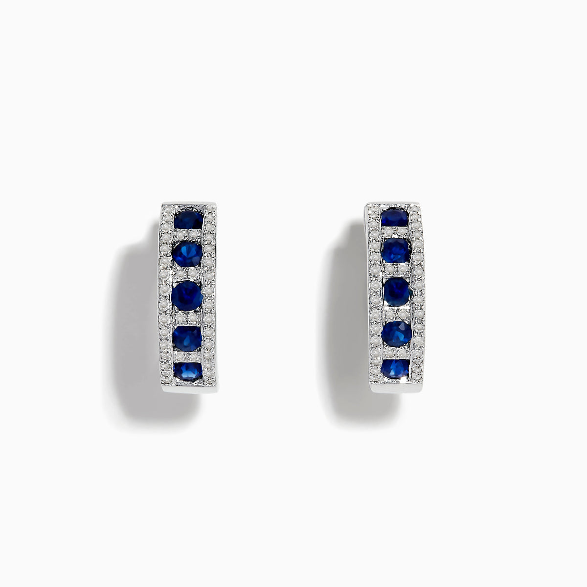 The Royale Bleu 14K White Gold Sapphire & Diamond Hoop Earrings, 1.03 TCW, showcase rows of sapphires bordered by diamond accents, elegantly displayed against a white background.