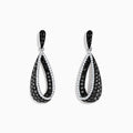 These 14K White Gold Black and White Diamond Earrings (1.30 TCW) feature elegant interlocking teardrop shapes adorned with sparkling diamond accents.