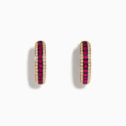 The Ruby Royale 14K Rose Gold Hoop Earrings feature a central row of rubies bordered by diamonds (0.55 TCW), elegantly displayed on a white background.