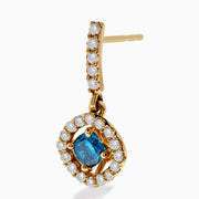 14K Yellow Gold Blue and White Diamond Dangle Earrings featuring a central blue gem encircled by a halo of white diamonds, with extra diamonds along the hooks, displayed on a white background.