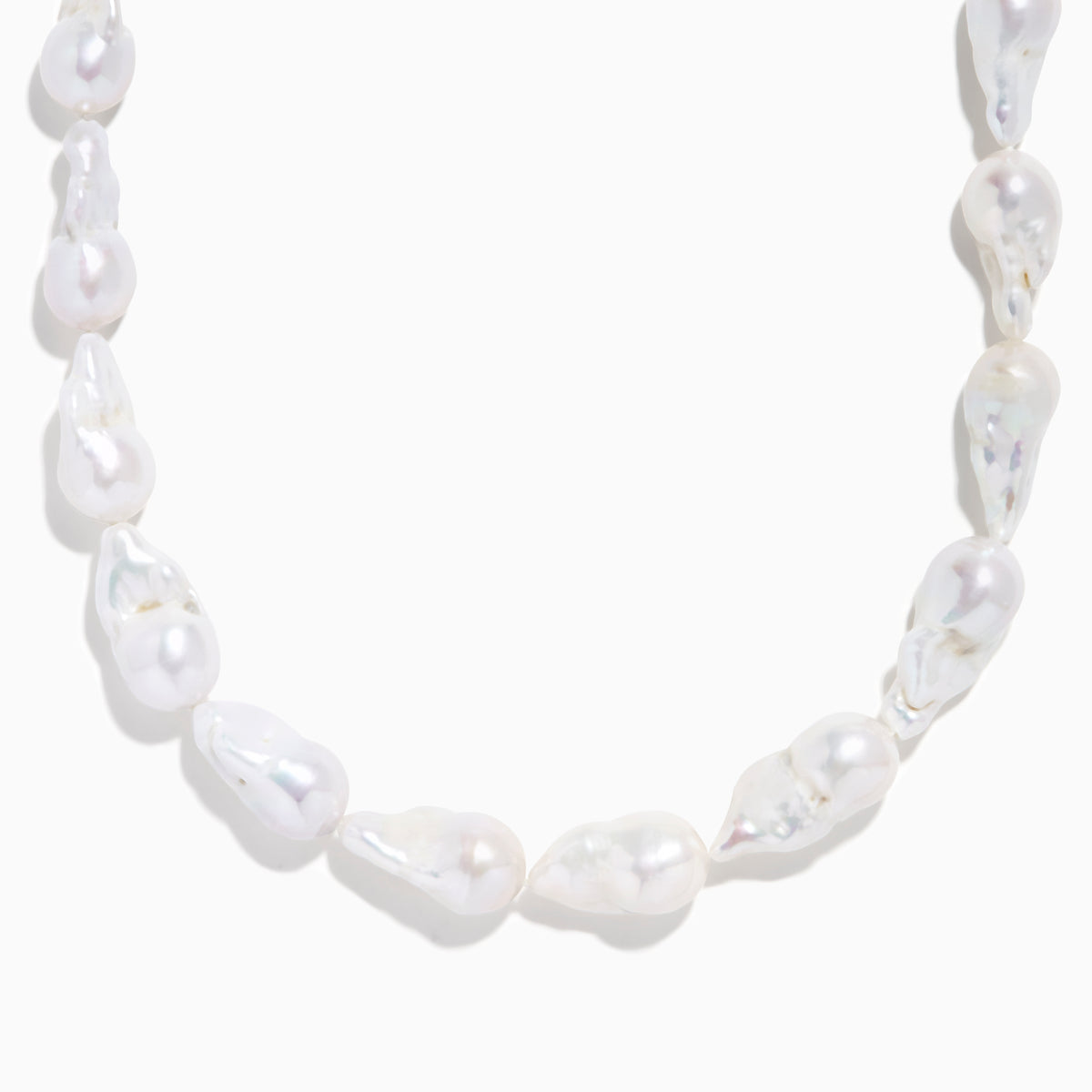 A close-up of the 14K Yellow Gold Freshwater Baroque Pearl Necklace featuring irregularly shaped white pearls and a 14K yellow gold clasp, set against a white background.