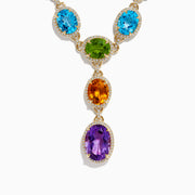 The Mosaic 14K Yellow Gold Diamond and Multi Color Gemstone Statement Necklace showcases four large oval gemstones—blue, green, orange, and purple—each encircled by diamonds in a vertical design on a white background.