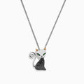 The Novelty Sterling Silver Black Diamond Cat Pendant, 0.28 TCW, features a cat design with green eyes, gold ears, a curled tail, and a body encrusted with black diamond stones.