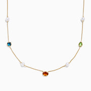 The Mosaic 14K Yellow Multi Color Gemstone and Fresh Water Pearl Station Necklace features evenly spaced blue, orange, and green gemstones with fresh water pearls on a gold chain, displayed on a white background.