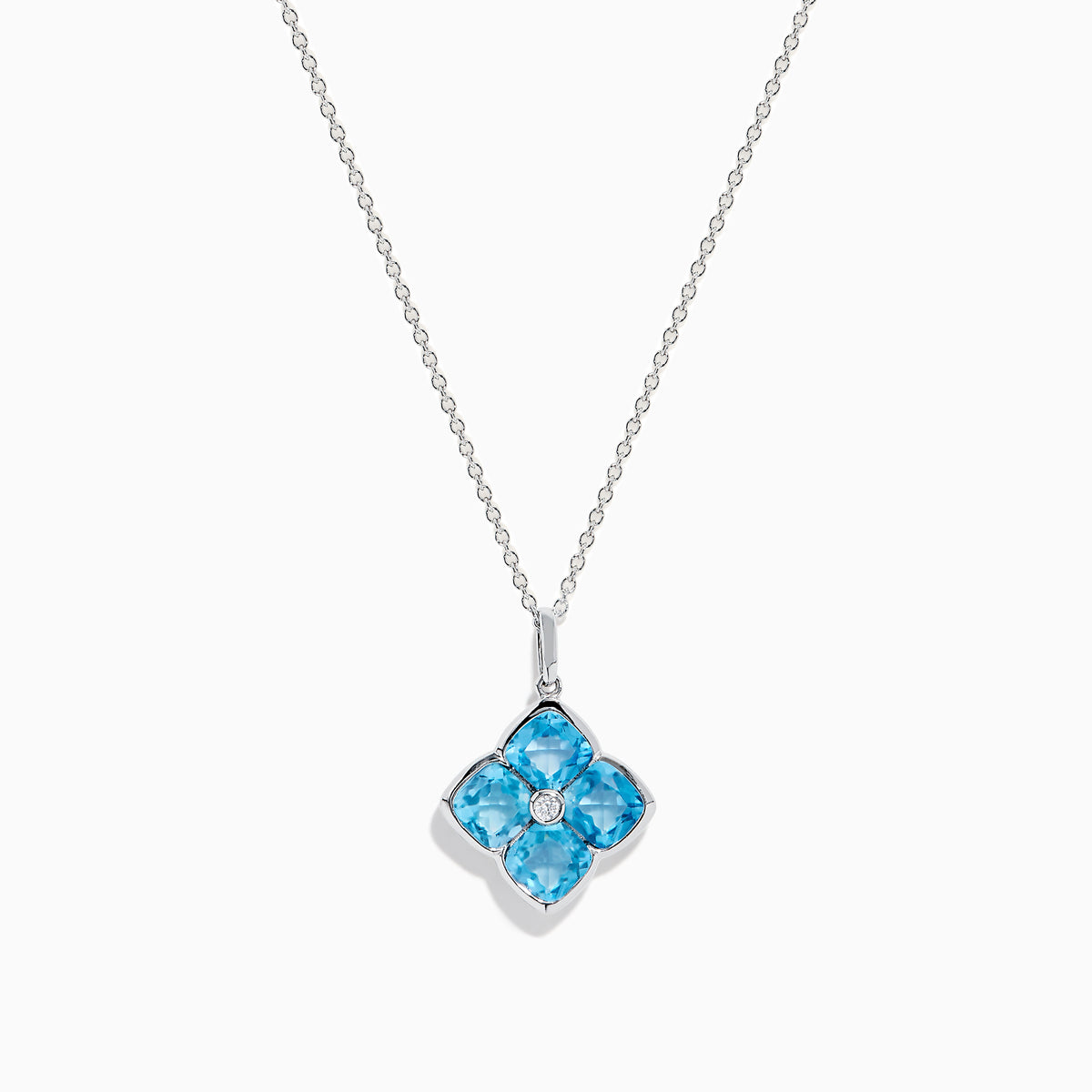 The Ocean Bleu 14K White Gold Blue Topaz and Diamond Pendant features a delicate chain and a four-petal flower blue topaz pendant accented with sparkling gemstones and a central diamond, set against a white background.