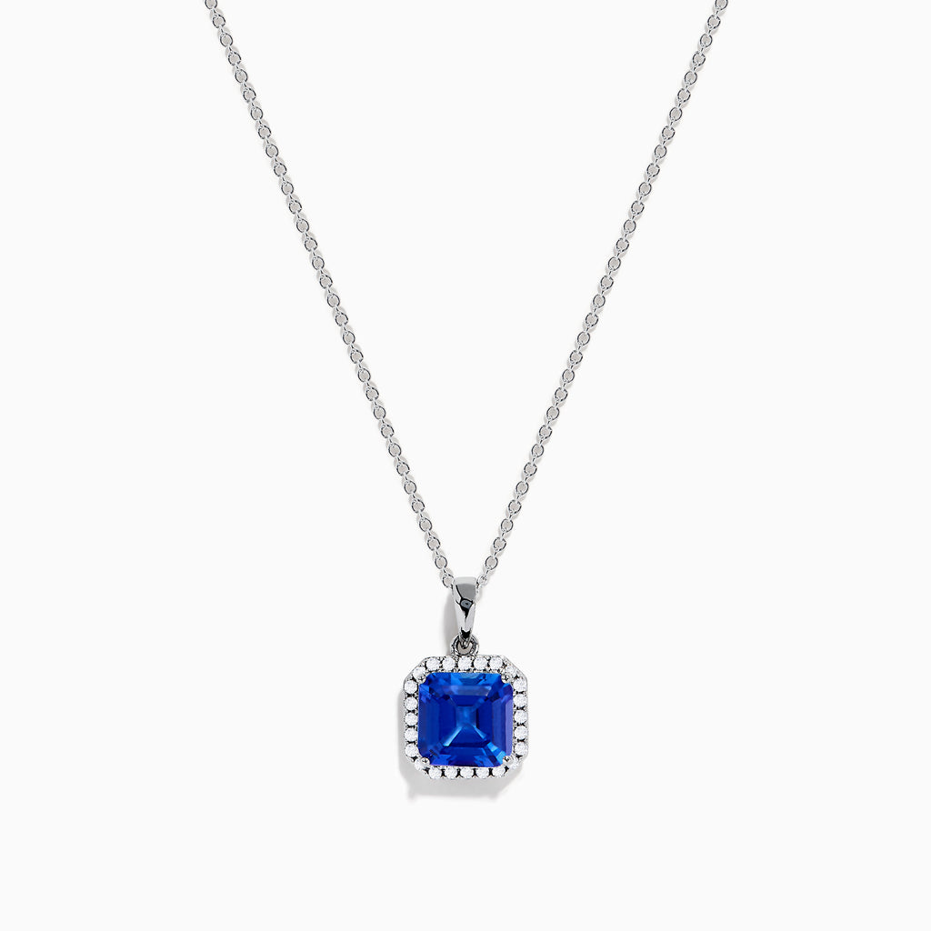 The Nahla Siri 14K Gold Tanzanite and Diamond Pendant features a square blue tanzanite gemstone surrounded by sparkling diamonds, displayed against a white background.