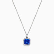 The Nahla Siri 14K Gold Tanzanite and Diamond Pendant features a square blue tanzanite gemstone surrounded by sparkling diamonds, displayed against a white background.