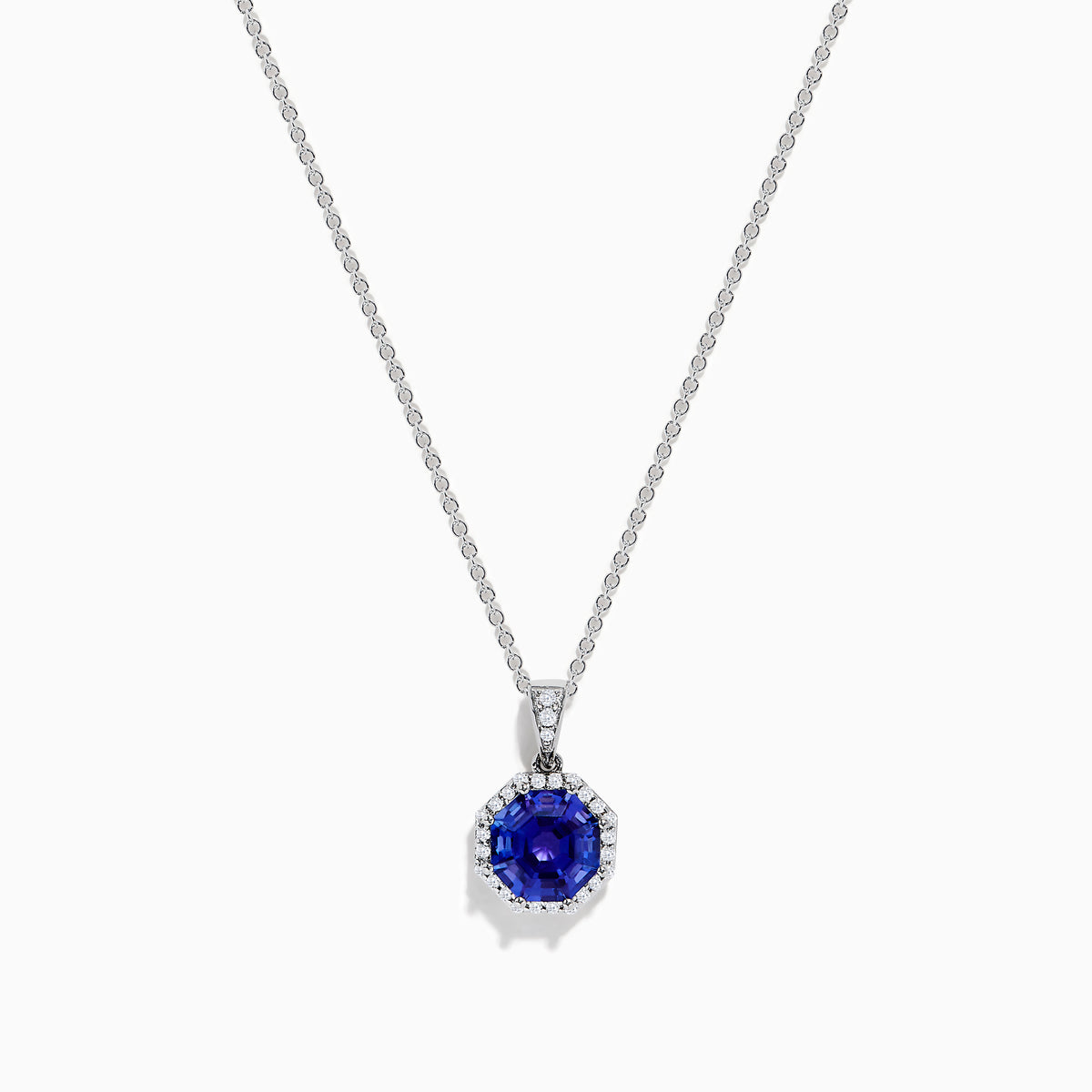 The Nahla Siri 14K Gold pendant showcases an octagon-cut tanzanite with a deep blue hue, surrounded by sparkling diamonds in a geometric setting.