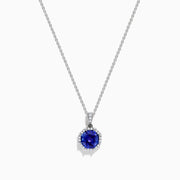 The Nahla Siri 14K Gold pendant showcases an octagon-cut tanzanite with a deep blue hue, surrounded by sparkling diamonds in a geometric setting.