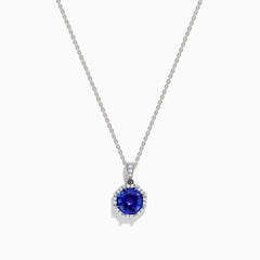 The Nahla Siri 14K Gold pendant showcases an octagon-cut tanzanite with a deep blue hue, surrounded by sparkling diamonds in a geometric setting.