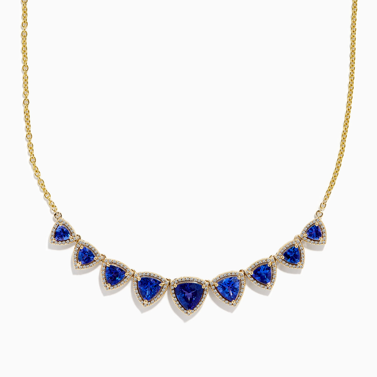 The Nahla 14K Yellow Gold Trillion Tanzanite and Diamond Necklace showcases seven deep blue trillion tanzanites, each framed by diamonds and evenly spaced along the chain.