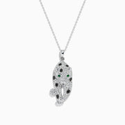 The Signature 14K White Gold Diamond & Emerald Pendant (0.79 TCW) showcases a leopard-shaped design with black spots, green emerald eyes, and diamond accents, elegantly hanging from a delicate chain.