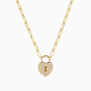 The Novelty 14K Yellow Gold Diamond Heart Lock Pendant is a yellow gold chain necklace with a diamond heart padlock, adorned with sparkling stones and a central keyhole design.