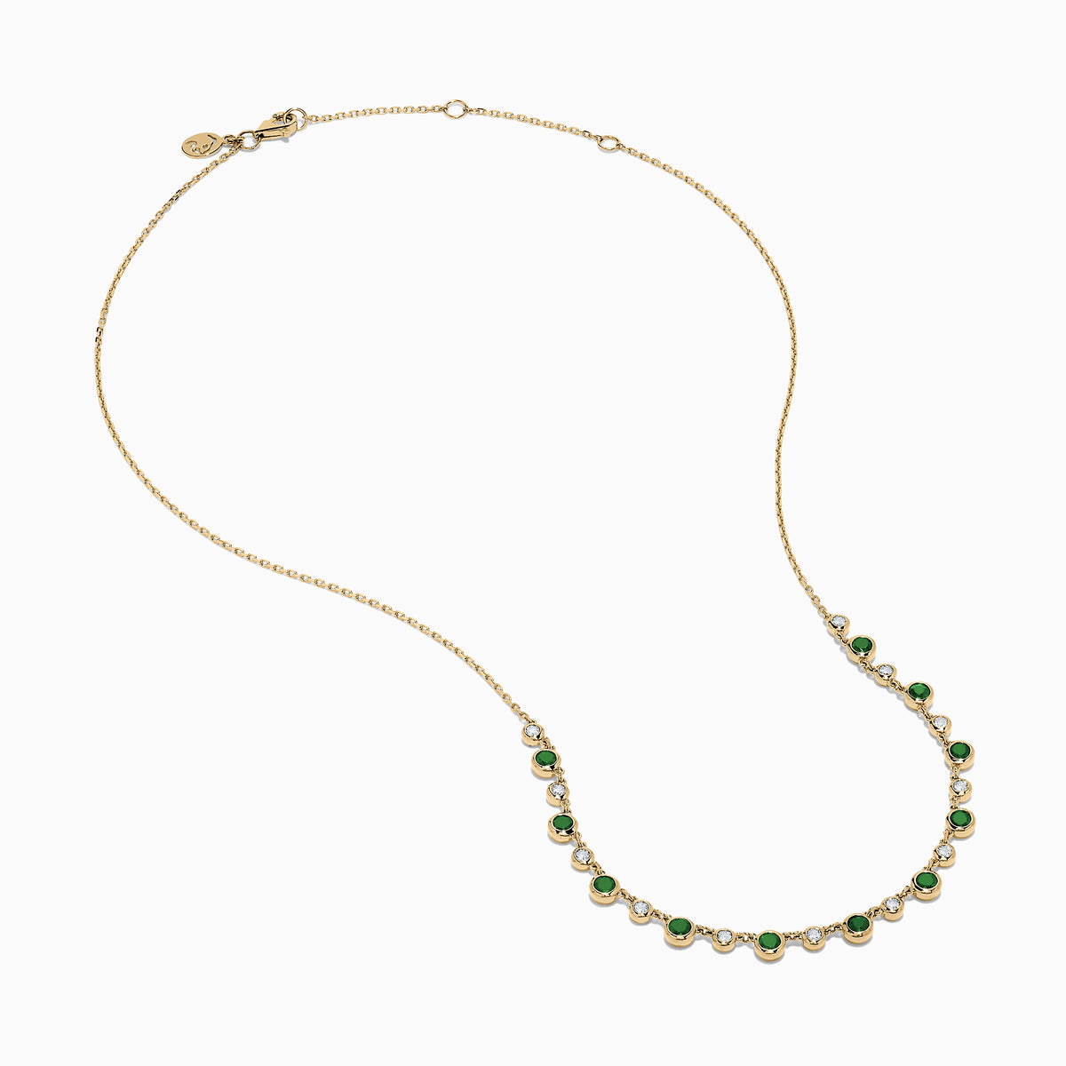 The 14K Yellow Gold Emerald and Diamond Bezel Set Station Necklace features alternating round emeralds and diamonds in bezel settings, evenly spaced along the front curve of the chain, displayed on a white background.