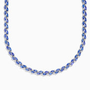 A close-up of the Nahla 14K White Gold Tanzanite and Diamond Necklace, showcasing pear-shaped blue tanzanites and sparkling diamonds set in a symmetrical design against a white background.