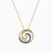This 14 Karat Yellow Gold Blue Diamond Swirl Pendant features alternating rows of blue and clear gemstones in a spiral swirl, with an elegant wave-like design on a delicate chain.