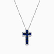 A 14K white gold cross pendant featuring blue sapphires and sparkling diamonds, totaling 0.91 carats—an elegant touch for any jewelry collection.