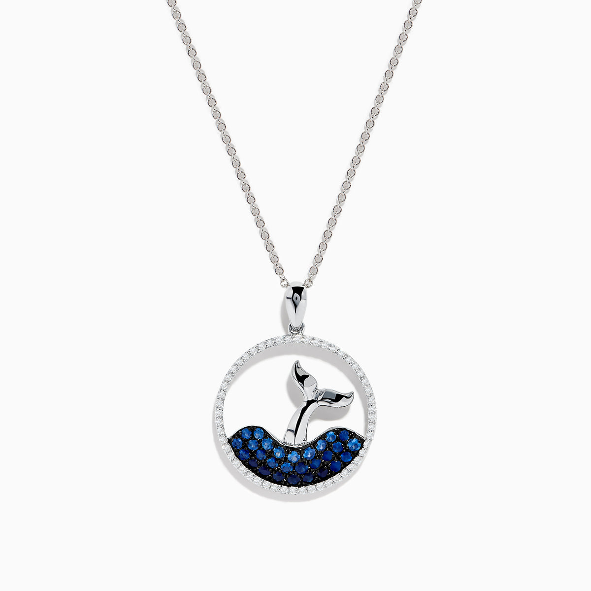 The Seaside 14K White Gold Sapphire and Diamond Whales Tail Pendant features a circular design with a whale tail emerging from sapphire-studded waves, bordered by sparkling diamonds.