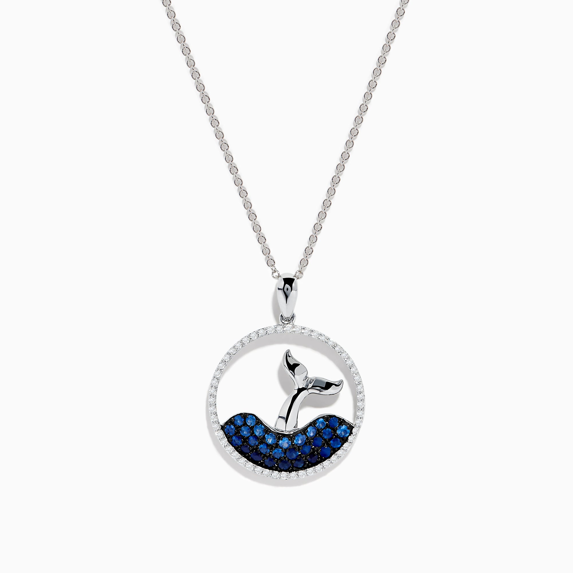 The Seaside 14K White Gold Sapphire and Diamond Whales Tail Pendant features a circular design with a whale tail emerging from sapphire-studded waves, bordered by sparkling diamonds.