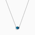 The 14K White Gold Pear Shaped Blue Diamond Necklace features a pear-cut blue diamond pendant in a minimalist setting, crafted from 14K white gold and showcased on a white background.