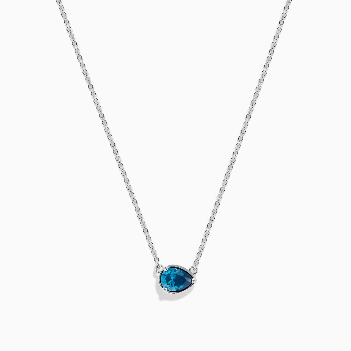 The 14K White Gold Pear Shaped Blue Diamond Necklace features a pear-cut blue diamond pendant in a minimalist setting, crafted from 14K white gold and showcased on a white background.