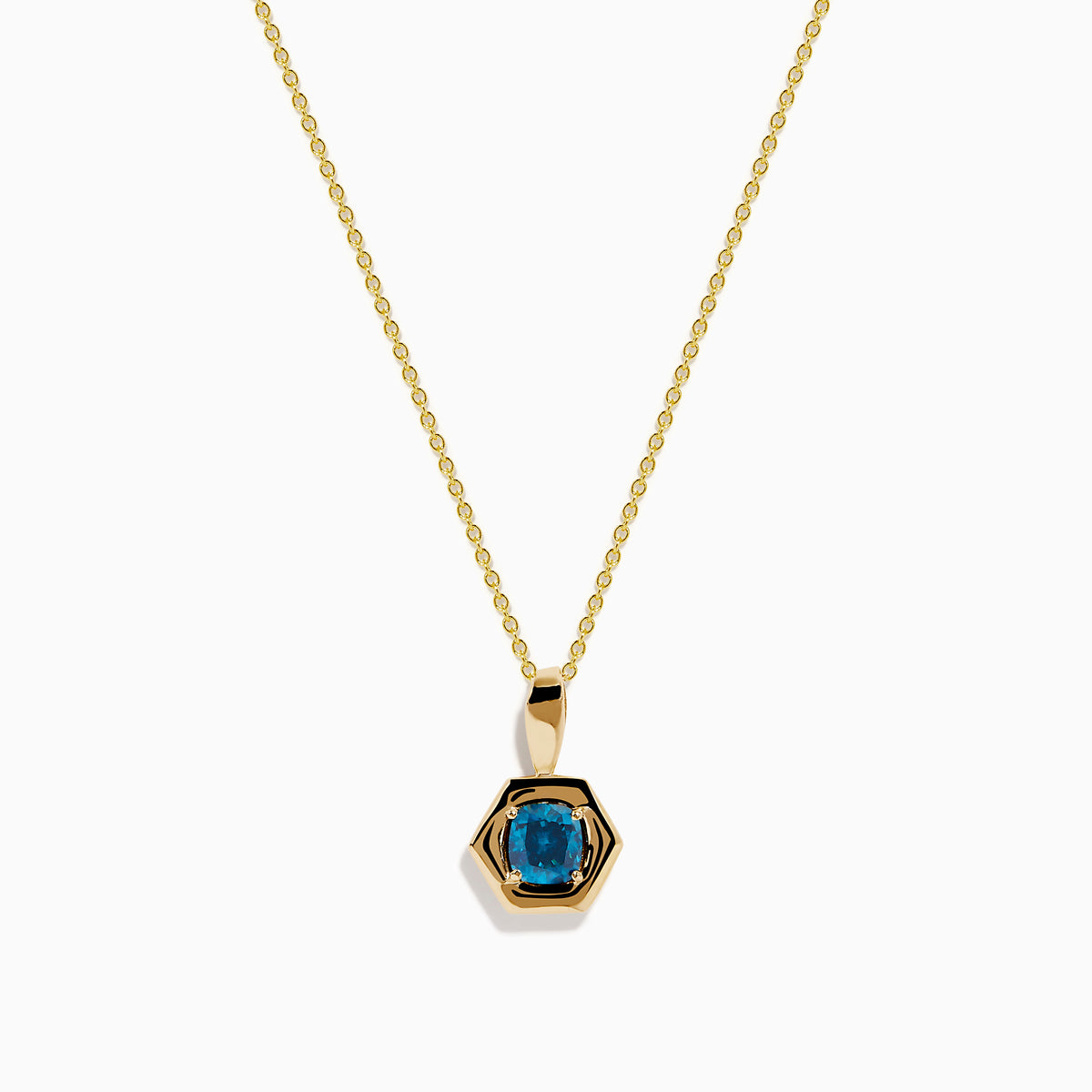 The 14K Yellow Gold Blue Diamond Cushion Pendant features a hexagonal pendant with a deep blue gemstone, set on a yellow gold chain and displayed against a white background.
