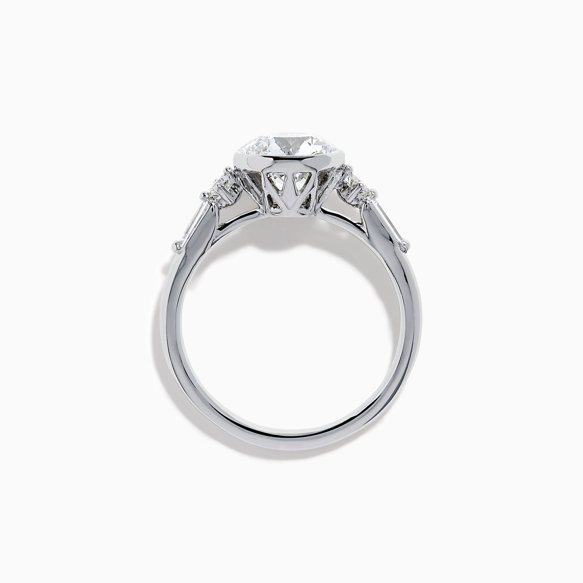 The Star Lab Grown Diamond Moderne Ring in 18K White Gold showcases a large round center diamond with two smaller diamonds on each side, set on a sleek, polished band against a white background.