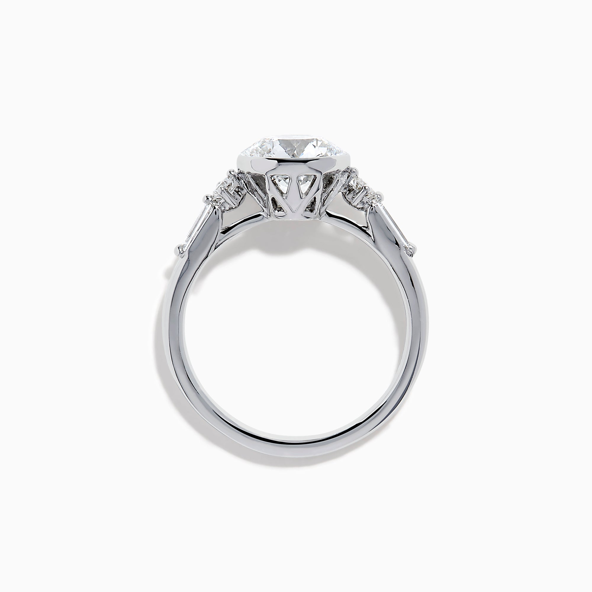The Star Lab Grown Diamond Moderne Ring in 18K White Gold showcases a large round center diamond with two smaller diamonds on each side, set on a sleek, polished band against a white background.