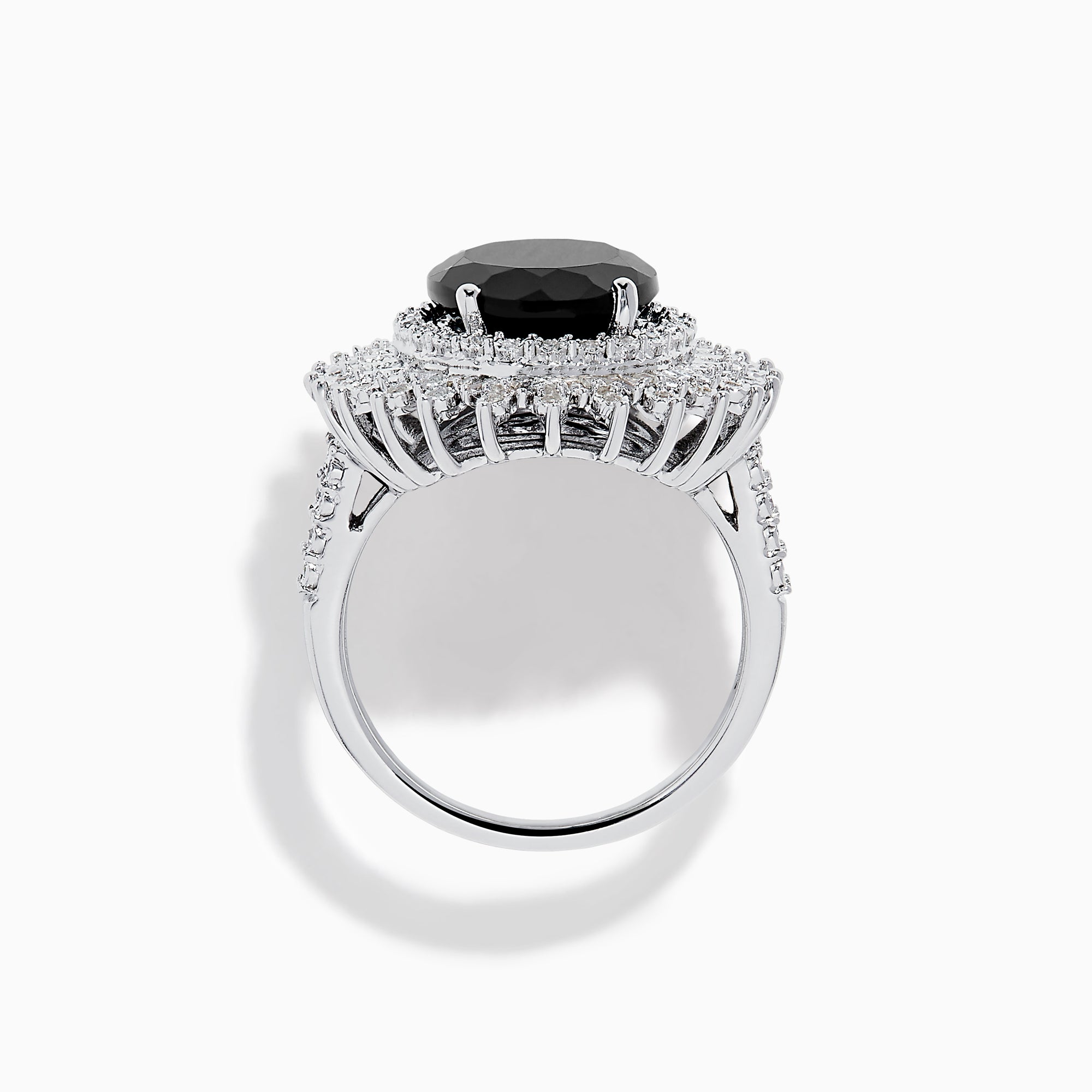 The 14K White Gold Onyx and Diamond Double Halo Ring features a large oval onyx surrounded by two rows of sparkling white diamonds, set on a white gold band and displayed against a white background.