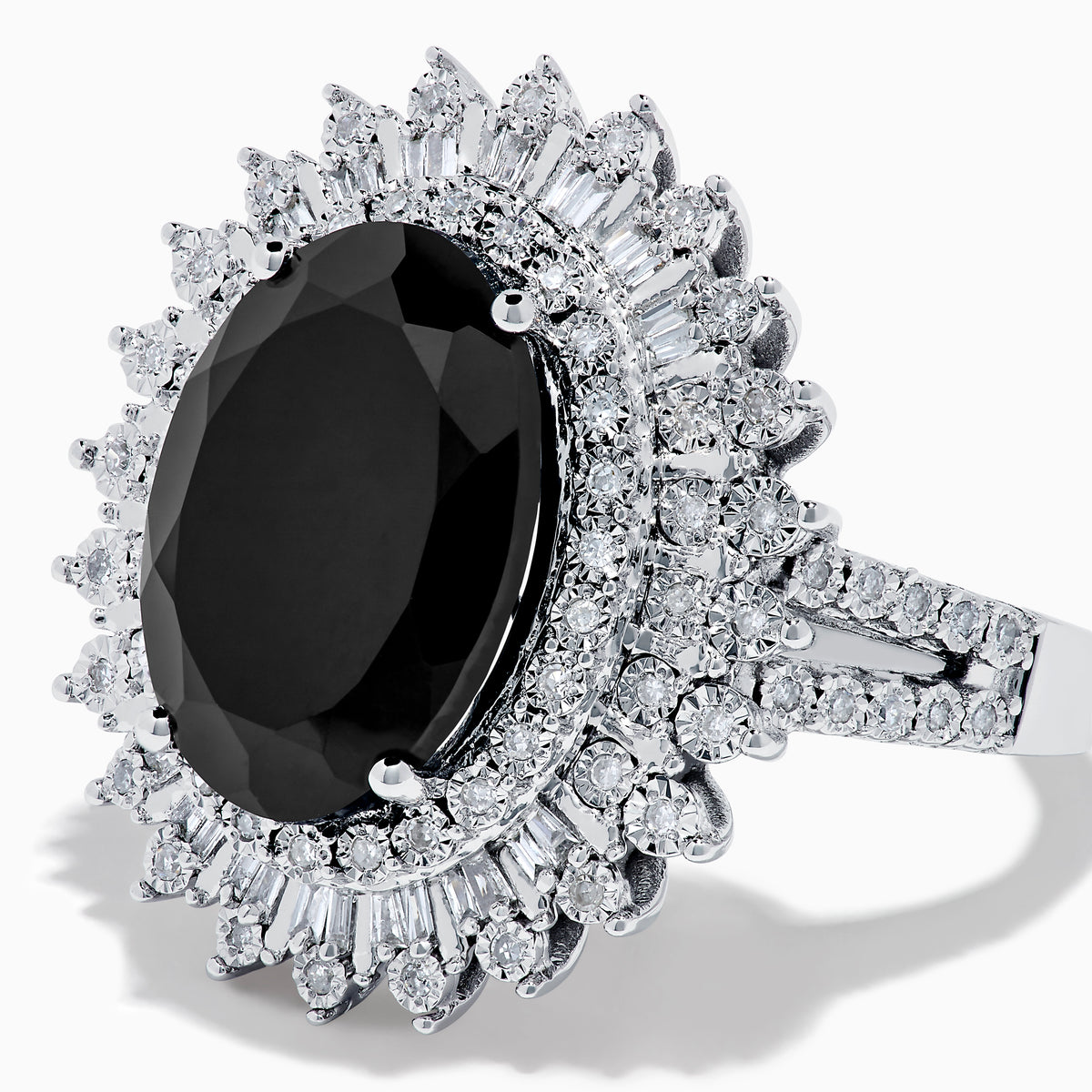 The 14K White Gold Onyx and Diamond Double Halo Ring features a large oval onyx surrounded by two rows of sparkling white diamonds, set on a white gold band and displayed against a white background.
