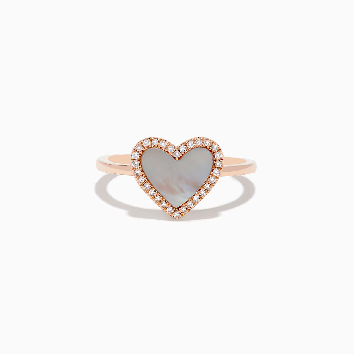 The 14K Rose Gold Mother of Pearl and Diamond Heart Ring features a heart-shaped mother-of-pearl centerpiece framed by sparkling diamonds.