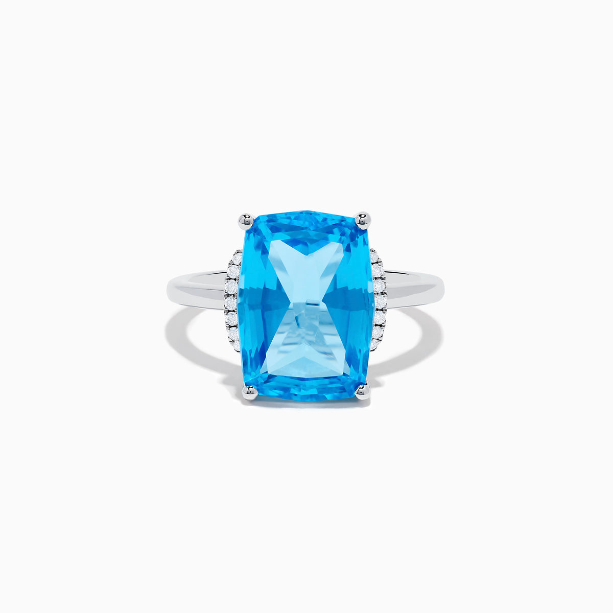 The Ocean Bleu 14K White Gold Blue Topaz and Diamond Ring showcases a large rectangular Blue Topaz gemstone, accented by sparkling diamonds on either side of the band.
