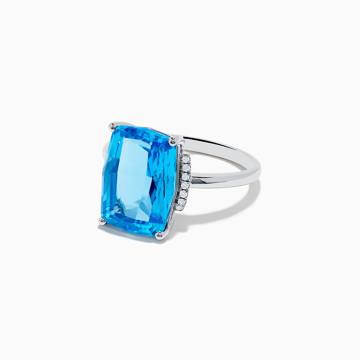 The Ocean Bleu 14K White Gold Blue Topaz and Diamond Ring showcases a large rectangular Blue Topaz gemstone, accented by sparkling diamonds on either side of the band.