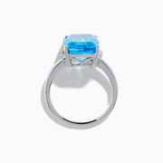 The Ocean Bleu 14K White Gold Blue Topaz and Diamond Ring showcases a large rectangular Blue Topaz gemstone, accented by sparkling diamonds on either side of the band.