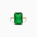 The 14K Yellow Gold Green Jade and Diamond Ring showcases a large rectangular green jade gemstone set with four prongs, complemented by small diamond accents on each side of the band.