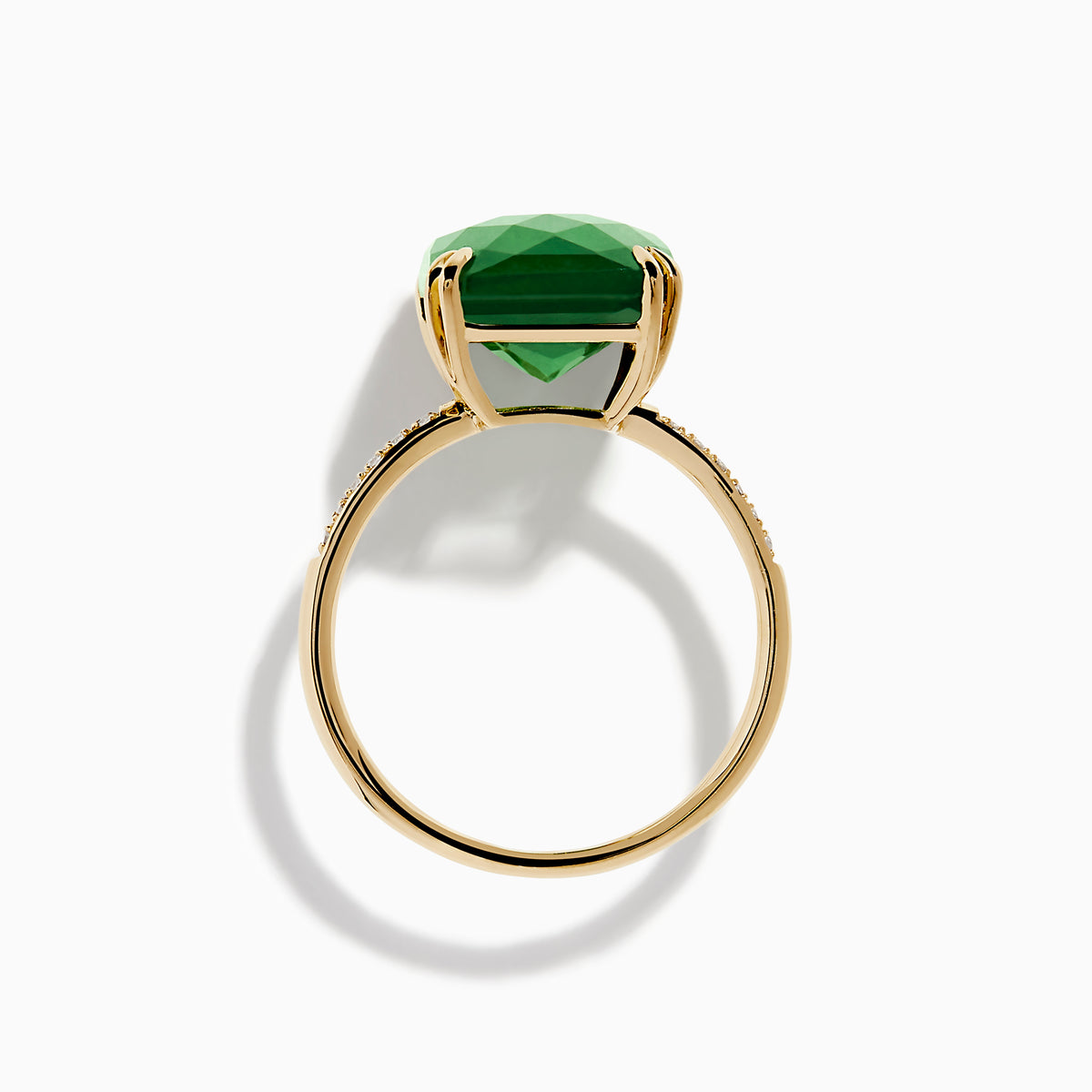 The 14K Yellow Gold Green Jade and Diamond Ring showcases a large rectangular green jade gemstone set with four prongs, complemented by small diamond accents on each side of the band.