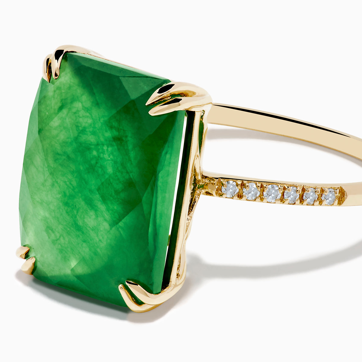 The 14K Yellow Gold Green Jade and Diamond Ring showcases a large rectangular green jade gemstone set with four prongs, complemented by small diamond accents on each side of the band.